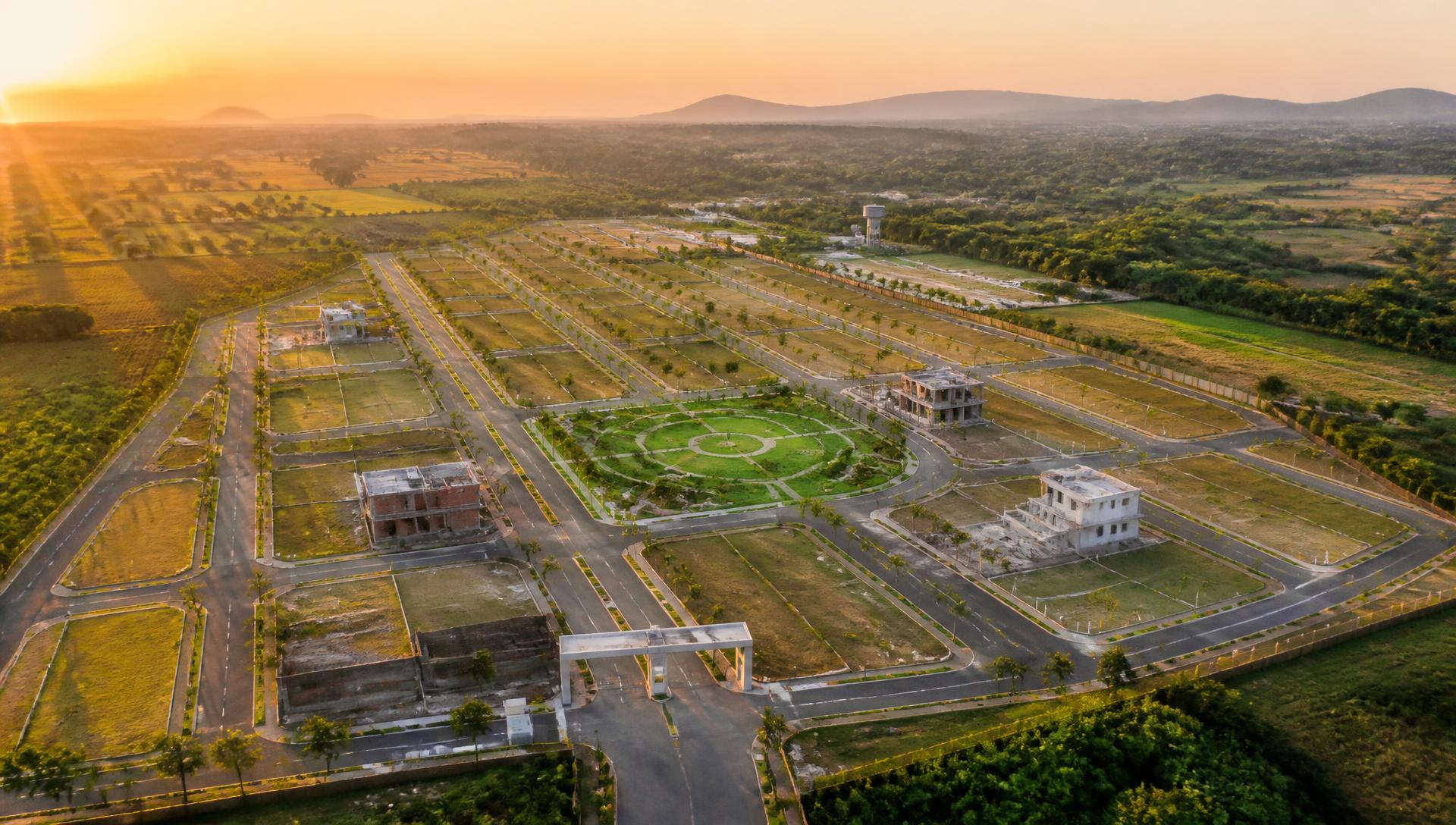 Aerial view of a planned residential plotted township at sunset